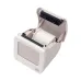 Front angled view of the Xprinter XP-P323B Thermal Barcode Label Printer printing a barcode label from its slot.