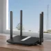 Cudy LT500 Router placed near window with four antennas, sleek design, and outdoor tower visible in background.