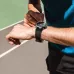 Close-up of a person's arm wearing the round BWOO BO-WA08 smartwatch during exercise, checking the elapsed time.