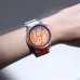Wrist view of HUAWEI WATCH GT Runner 2 on red-orange strap displaying time, weekly distance, RAI, and WTL stats.