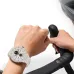 Cycling scene with HONOR CHOICE Watch 2 Epic in white strap visible on wrist gripping bicycle handlebar.