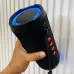 Handheld view of Unikyy S18 Portable Bluetooth Speaker showing cylindrical body with LED ring and control buttons on side