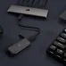 A top-down view of the EX100U external SSD connected to a multi-port hub on a dark desk next to a keyboard.