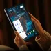 Angled handheld view of CHUWI Hi10 X2 Windows 11 Tablet displaying interface on screen while being used with both hands indoors