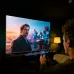 Living room view of Haier 43P7 PRO Google TV in use with remote voice control and sound wave graphics.