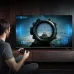 Living room view of Haier 55P7 PRO Google TV in use with remote voice control and sound wave graphics.