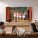 Living room view of Samsung 85U8500H 85 inch Crystal 4K UHD LED Smart TV showing people watching colorful display