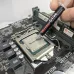 Close-up view of Maxtor CTG8 Thermal Paste being applied to CPU on motherboard for improved thermal conductivity.
