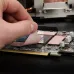Thermal Grizzly Minus Pad 8 Thermal Pad showing applying on components