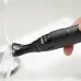 Close-up of Philips MG1100/16 1000 Series Trimmer rinsed under running water showing waterproof design.