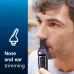 Lifestyle view of Philips MG3710/33 Trimmer used for nose hair grooming with blue background highlighting sensitive area trimming.