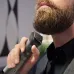 Close-up of Philips MG7940/15 Trimmer in use on thick beard with green light indicator and ergonomic black handle design.