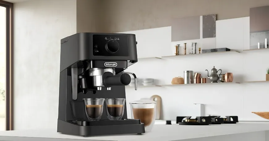 Front view of a DeLonghi EC230 Stilosa manual espresso machine with twin glass cups on a modern kitchen counter.